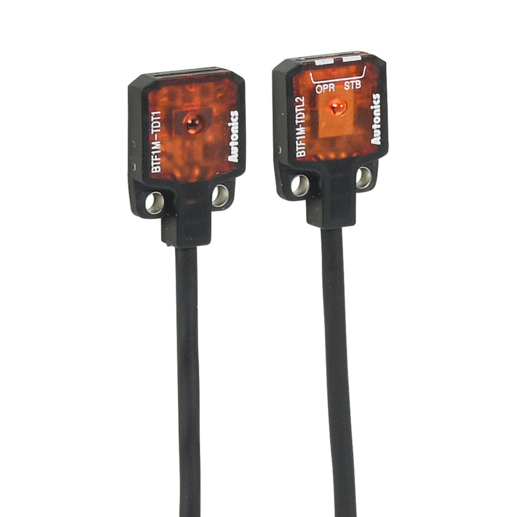 BTF1M-TDTL - Autonics photoelectric sensor, rectangular, through-beam pair, visible red, 0-1m sensing distance, light-on, NPN, 10.8-26.4 VDC operating voltage, 15.8 x 13 x 3.7mm body, polybutylene terephthalate, 3-wire, pigtail.